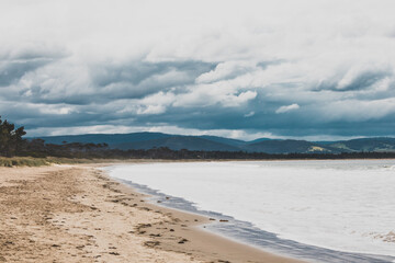 beautiful view of Seven Mile Beach just outside the city of Hobart in Tasmania, Australia on an overcast day with stormy clouds