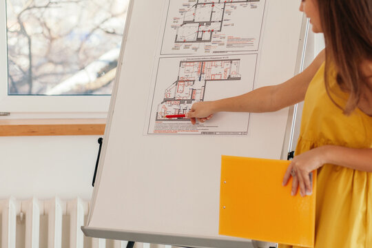 Anonymous architect showing blueprints during conference