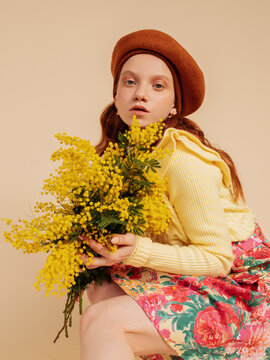 Stylish ginger woman with yellow flowers