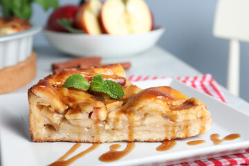 Slice of traditional apple pie on plate, closeup