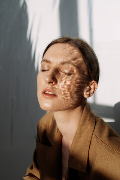 Female model with reflection of water on face
