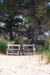 Fototapeta na wymiar couple of simple benches made of upcycled wooden pallets on a beach in Tasmania, Australia