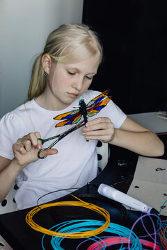 Teen girl making toy dragonfly