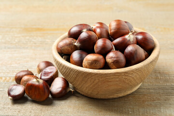 Fresh sweet edible chestnuts on wooden table
