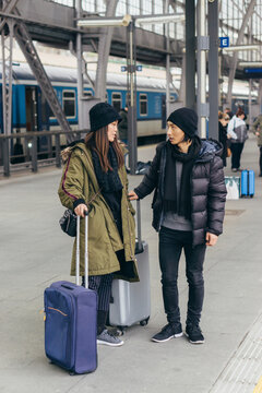 Young Asian couple waiting for a train