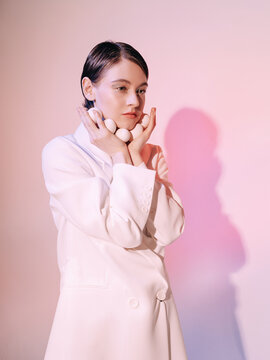 Stylish woman with eggs under chin