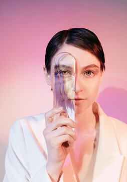 Attractive woman looking at camera through glass