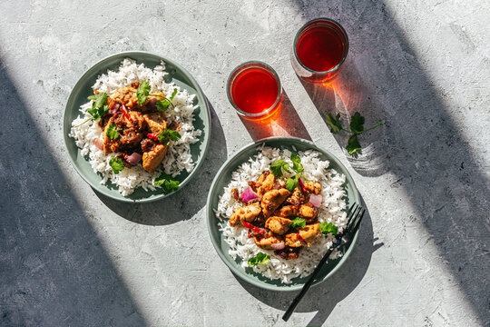 Stir-fry chicken with basmati rice on plates