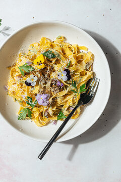 Homemade pasta with edible flowers