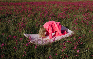 Woman in bright suit in summer fields
