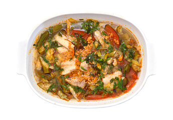 Bowl of spicy seafood soup on white