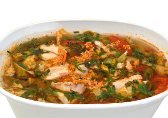 Bowl of spicy seafood soup on white