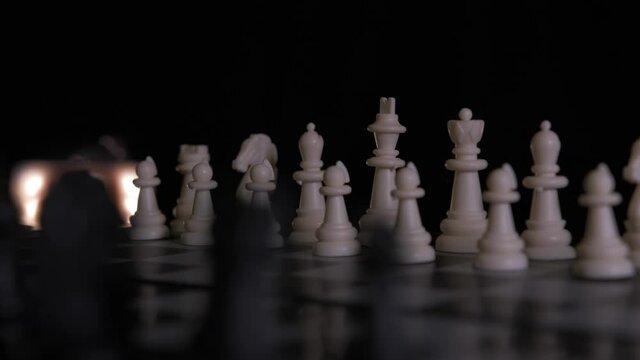 Close-up of a rotating chess board, set up in the ready position waiting for a game to begin. Concept of strategy or the debate in choosing a side.