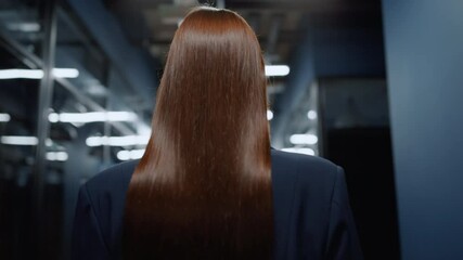 Focused woman heading on meetup in office. Businesswoman walking in corridor
