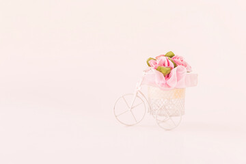 Pink rose paper flower on white bicycle, vintage tone style, valentine concept background 