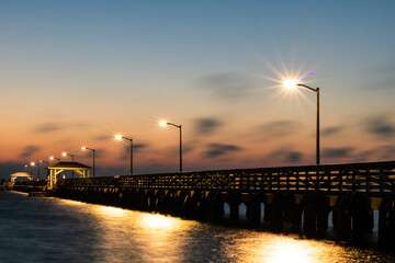 Fototapeta premium One Fisherman on the Pier in the morning