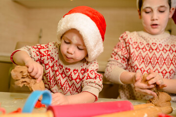 Fototapeta na wymiar Children making cookie for Santa in home kitchen. Homemade baking