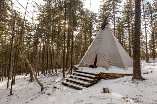 The pristine nature of the Zeya reserve. White chum wigwam stands in the middle of the snowy taiga