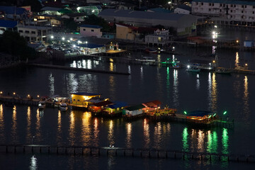 Colorful aquaculture village with water and light trail