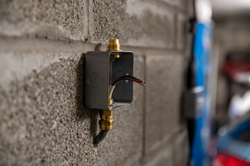 Isolated metal box socket outer case on garage wall ready to be wired