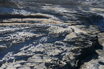 The rocks with the ocean and with the strongwomen waves near the Maroubra beach in Sydney, Australia