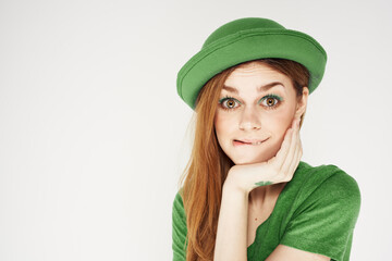 shamrock happy girl in a green hat and a t-shirt on a light background St. Patrick's Day