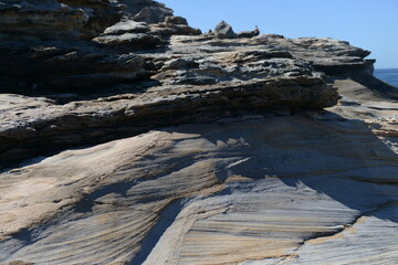The rocks with the ocean and with the strongwomen waves near the Maroubra beach in Sydney, Australia