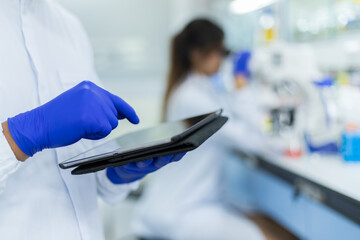 Picture of hand scientists using tablet a search data in lab , Concept science and technology,...