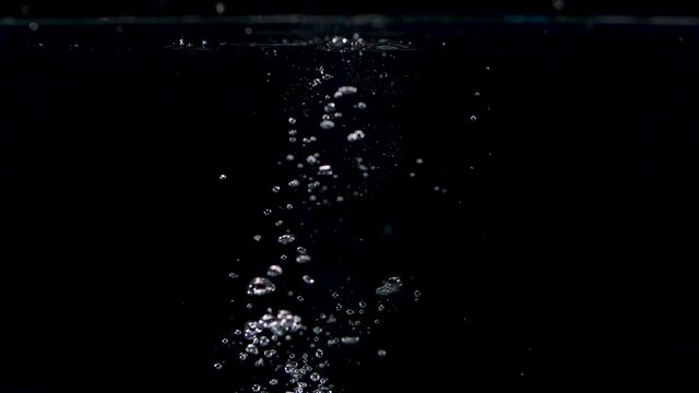 Abstract Stones Falling into Water in Slow Motion with Lots of Bubbles