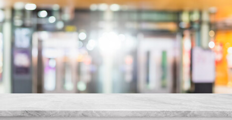 Empty white marble stone table top and blur glass window interior shopping mall banner mock up abstract background - can used for display or montage your products.