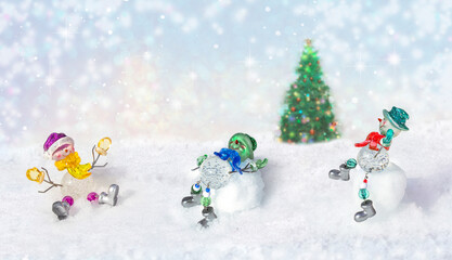 Fototapeta na wymiar Merry Christmas - funny snowmen carefree on snow in winter new year landscape. Beautiful bokeh circles on snowy background, banner