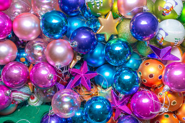 Colorful and bright balls, stars and Christmas decorations forming a background