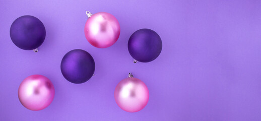 Purple and pink Christmas balls on a purple background for Christmas decoration