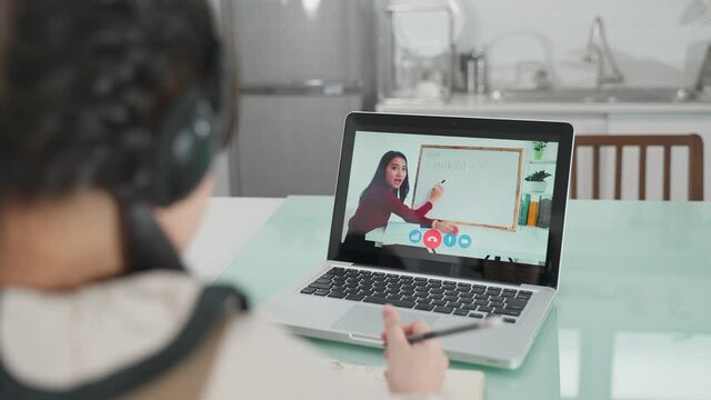 Homeschool Asian little young girl learning online class with teacher.
