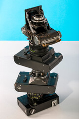 Pyramid from old film cameras on a colored background