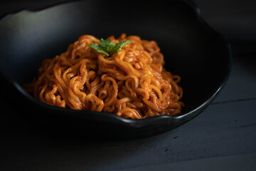 Korean spicy instant noodles in black bowl