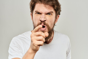 Fototapeta premium man in white t-shirt emotions expressions gesture with hands cropped view light background