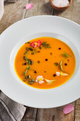 Yellow Pumpkin Soup on wooden table