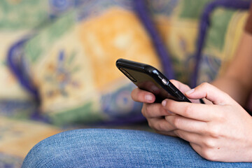 Hands of a young woman using her smart phone