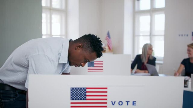 African-american man voter in polling place, usa elections concept.