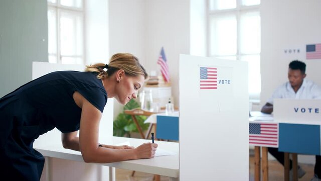 Portrait of woman voter in polling place, usa elections concept.