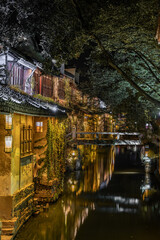 Obraz premium Night view of the river and architecture in Zhouzhuang, an ancient Chinese village in Jiangsu province, China.