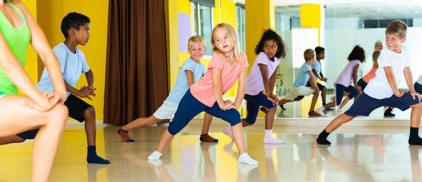Emotional children performing modern dance in fitness studio. High quality photo