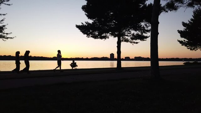 persons walking after sun set on the horizon
