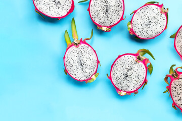 Fototapeta na wymiar Dragon fruit or pitaya on blue background. Delicious tropical exotic fruit. Top view