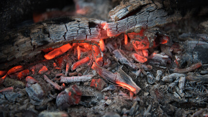 Fire with coals in the fire. Open fire, dying embers. Beautiful rich colors.