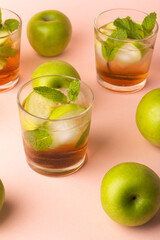 glass of refreshing drink with green apples and mint.