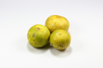 Pile of fresh and organic ripe lime isolated on the white background. Famous tropical ingredients in Asia restaurant. Juicy with high vitamin C and sour tasty. 