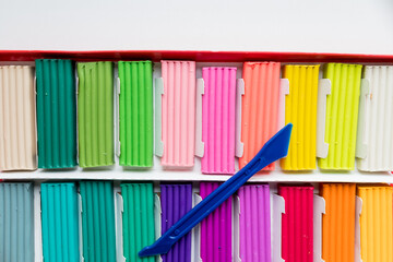 Colorful kid's plasticine on white background, Colorful dough modeling clay.Multicolored briquettes of soft plasticine for modeling with soft focus. Plastic colorful material for kids art education.