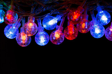 Glowing blue and red Christmas lights on a dark background